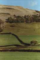 bare hillside above walled fields