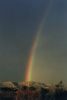 rainbow at dawn above Muizenberg Mountain
