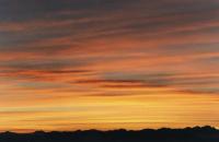 sunrise on layered cirrus over mountains