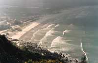 view over Muizenberg with sun on breaking waves