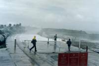 figures with splash on pier with danger sign