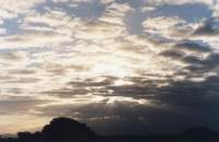 sunbeams behind clouds