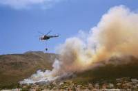 Helicopters water-bombing the fire above Muizenberg