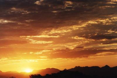 sunrise glow and clouds over mountains