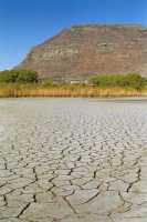 Mud cracks at Zandvlei in late-summer with Muizenberg Mountain