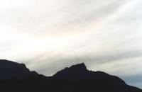 cirro stratus over Table Mountain with faint halo around sun