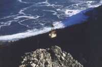 old Table Mountain cable-car over cliffs and sea
