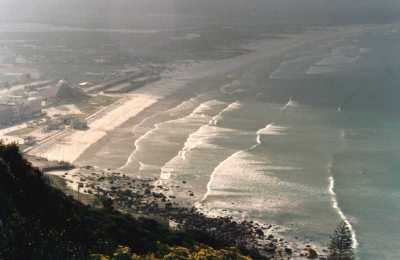 view over Muizenberg with sun on breaking waves