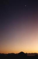 clear sunrise with crescent moon