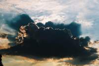 towering cumulus cloud backlit with shadows